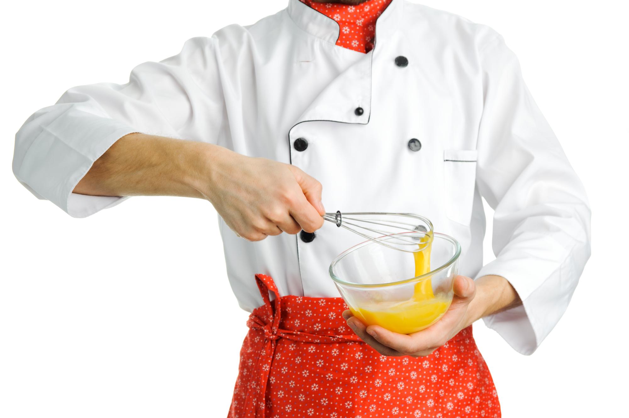 Chef demonstrating sauce technique in studio